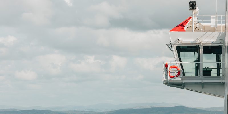 The port bridge wing of Manxman with mountainous countryside in the fardistance over the Lune Estuary