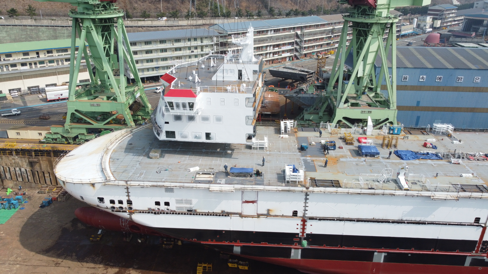 Ferry in shipyard being built with cranes around it