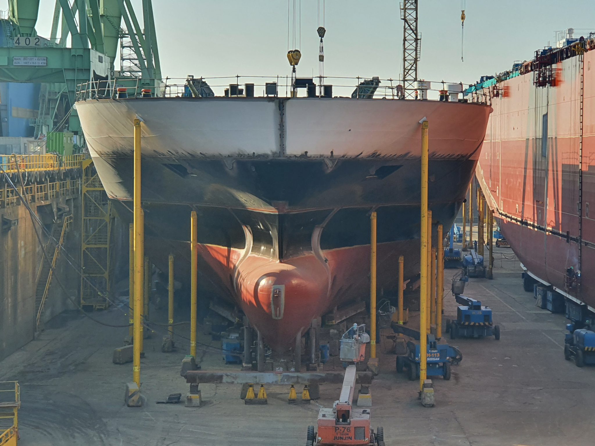 Ferry in shipyard being built with cranes around it