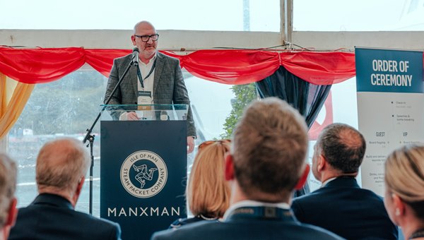 Man at podium looking at the crowd at an order of ceremony 