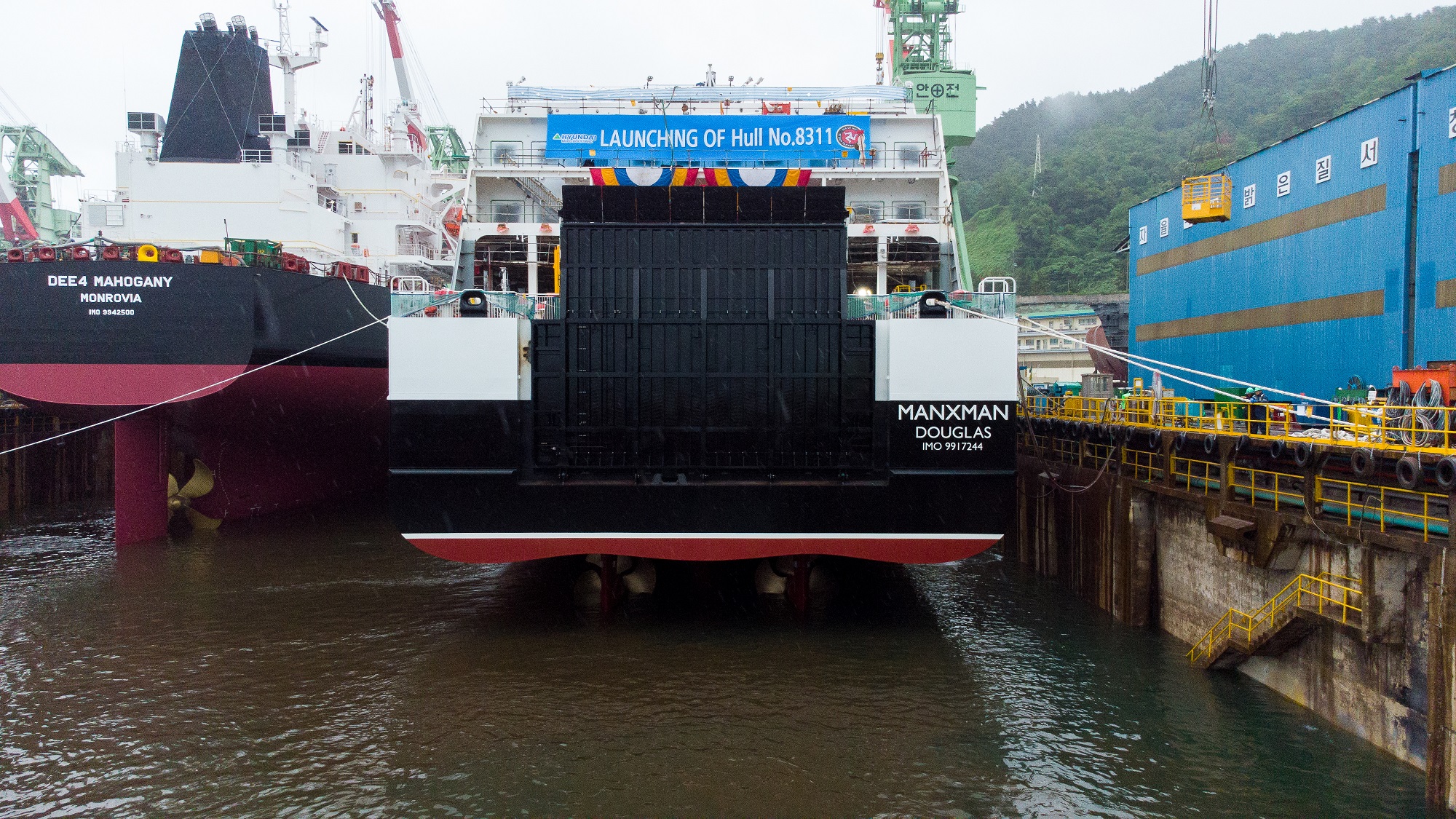 Back profile of ferry being launched from ship yard into the sea