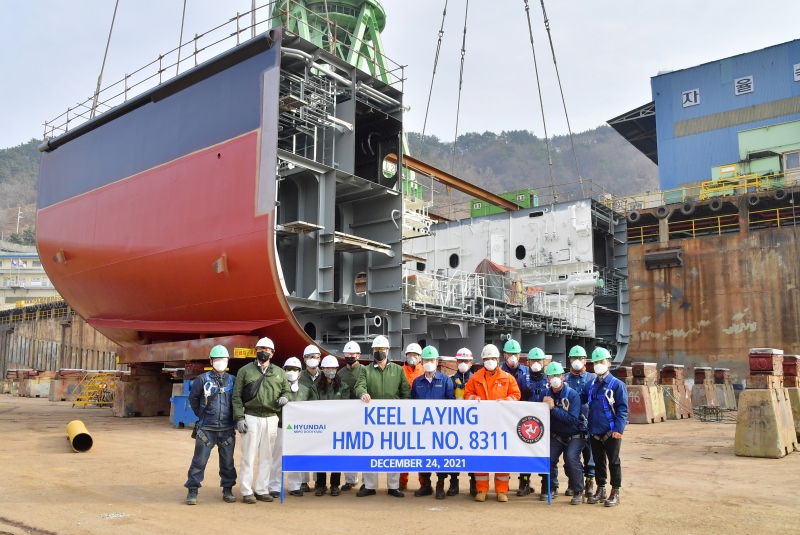 Group of workers posing for a photo of the keel been added to the Manxman ferry at a dockyard in South Korea