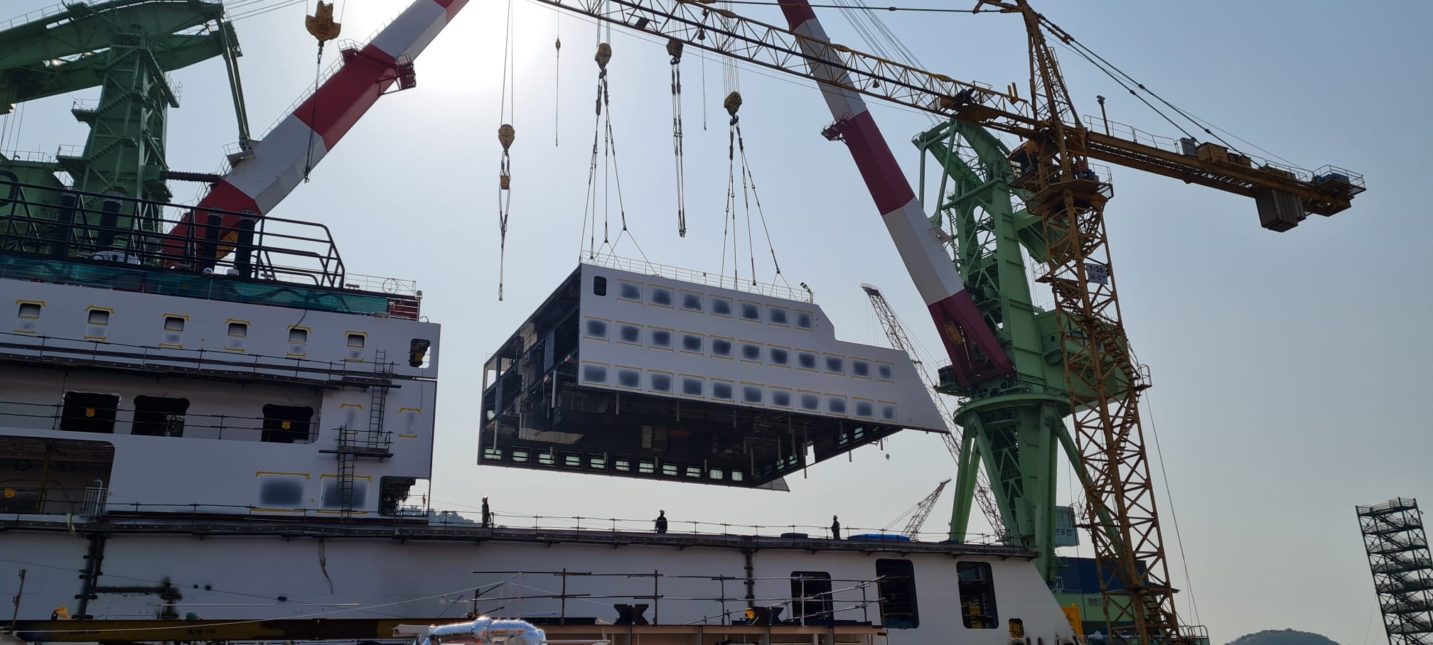 Ferry in shipyard being built with cranes around it