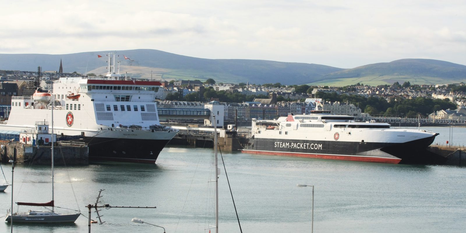 Steam Packet Company Fleet in Douglas Harbour showing a blue sea and blue sky with a couple of clouds